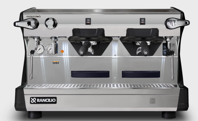 Silver Rancilio espresso machine with two brewing groups, steam wands, and a water spout.