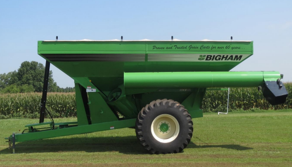 A john deere tractor with a chopper lister attached to it