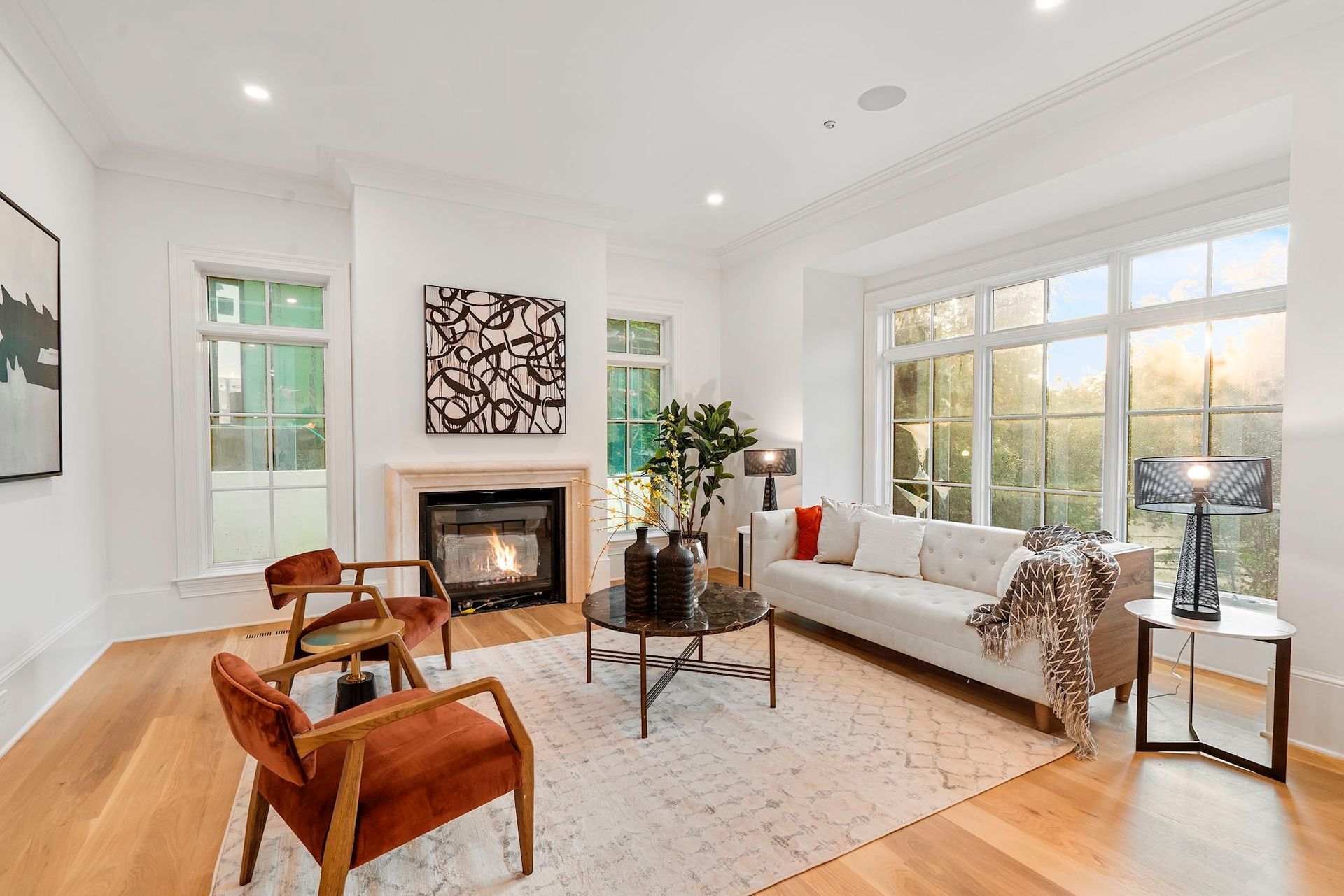 A living room with a couch , chairs , coffee table and fireplace.