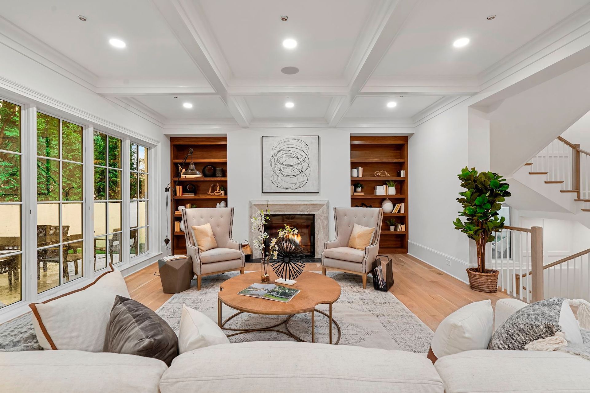 A living room with a couch , chairs , coffee table and fireplace.