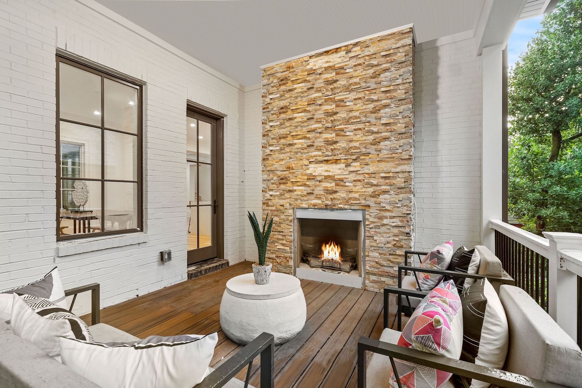 There is a fireplace on the porch of a house.