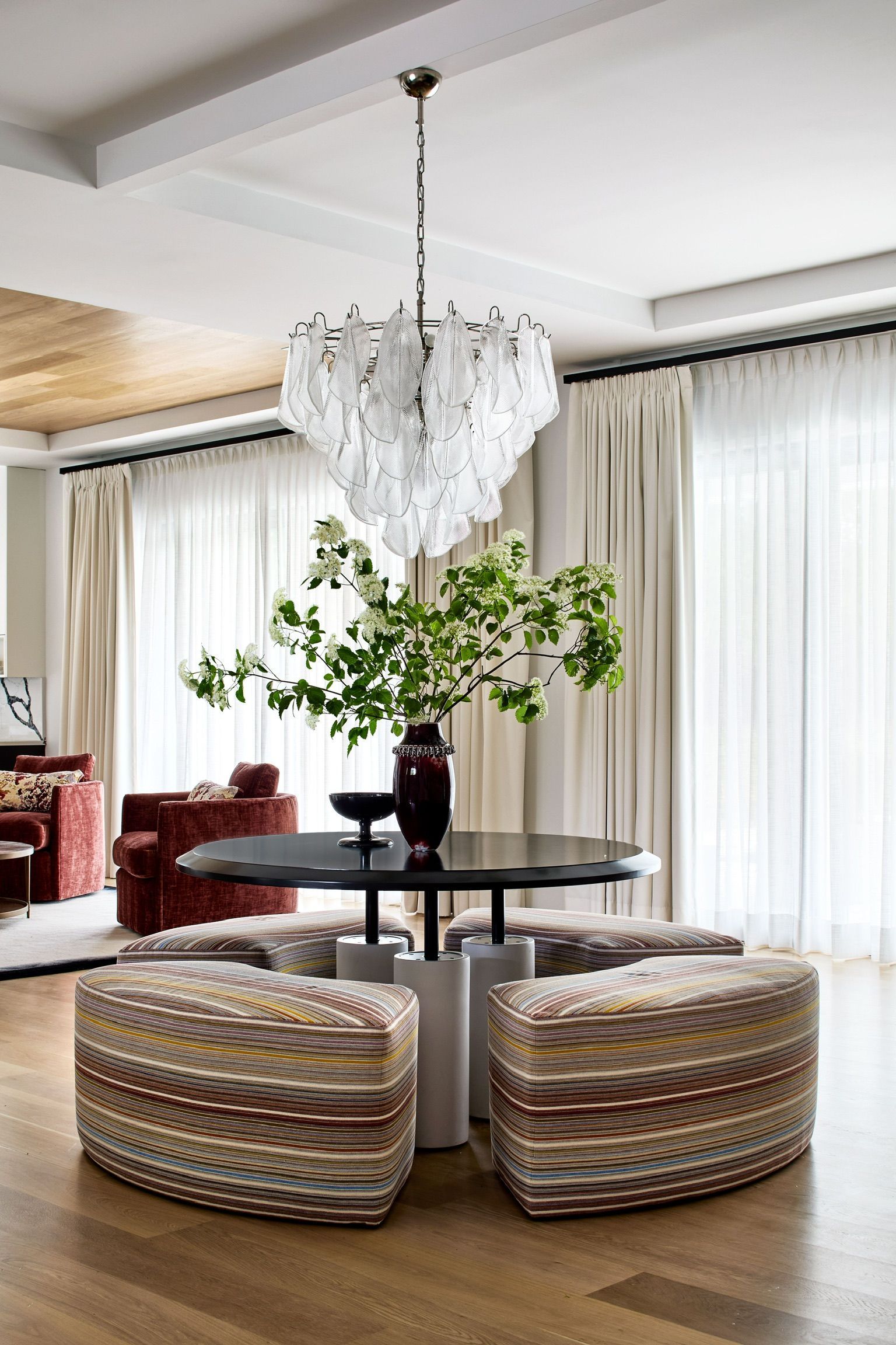 A living room with a table and chairs and a chandelier.