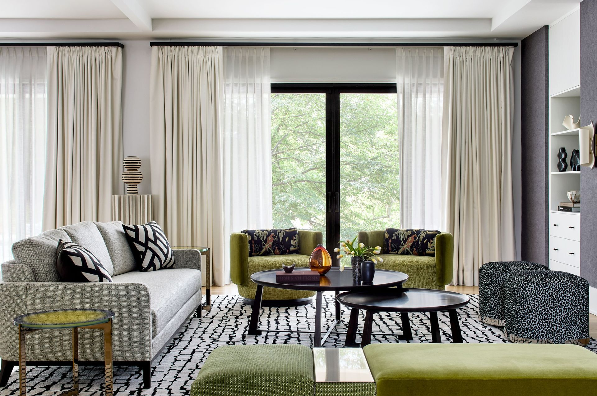 A living room filled with furniture and a large window.