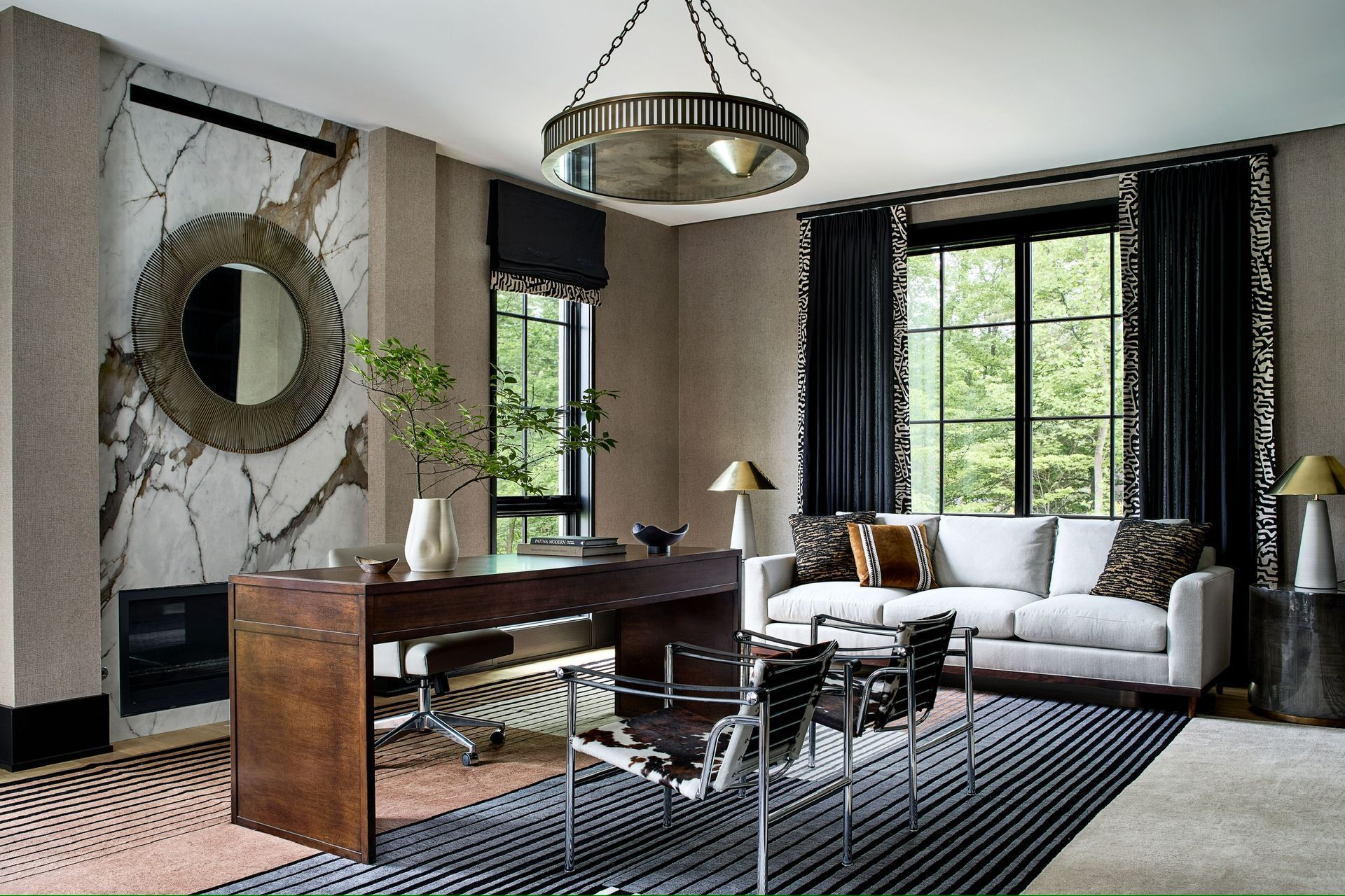A living room with a couch , desk and chairs