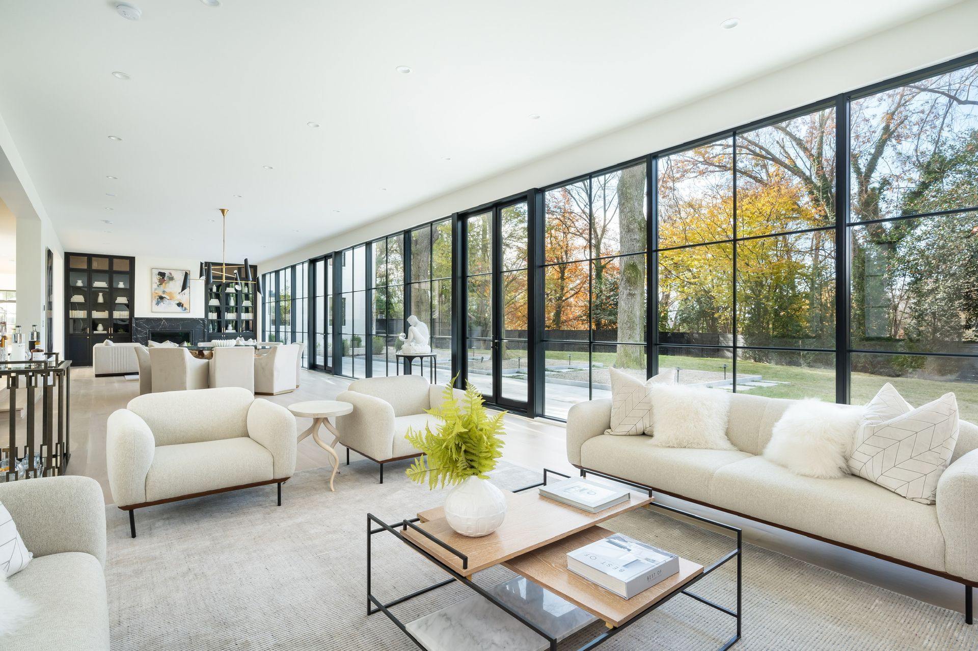 A living room with a couch , chairs , and a coffee table.
