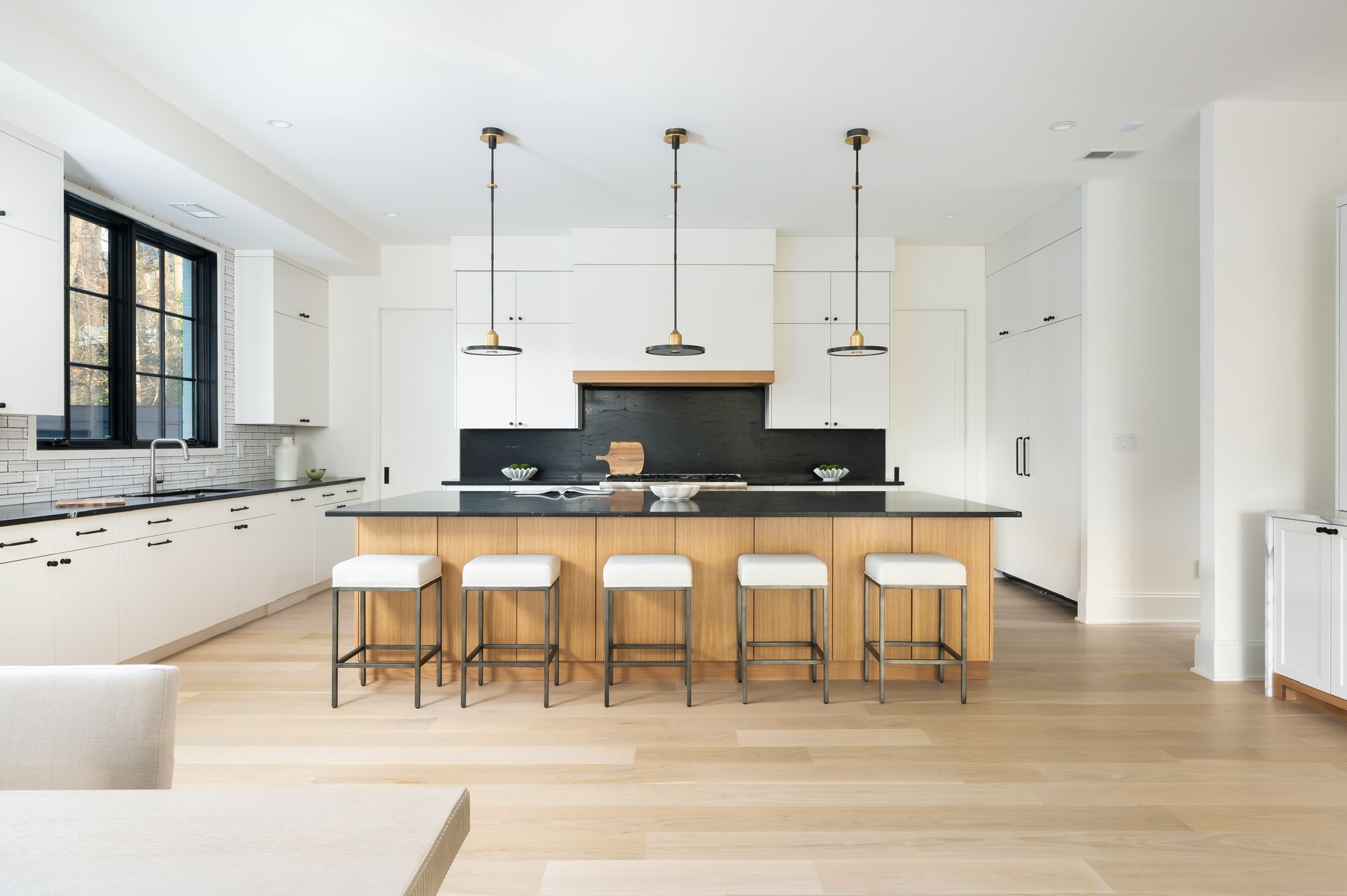 A large kitchen with a large island and stools