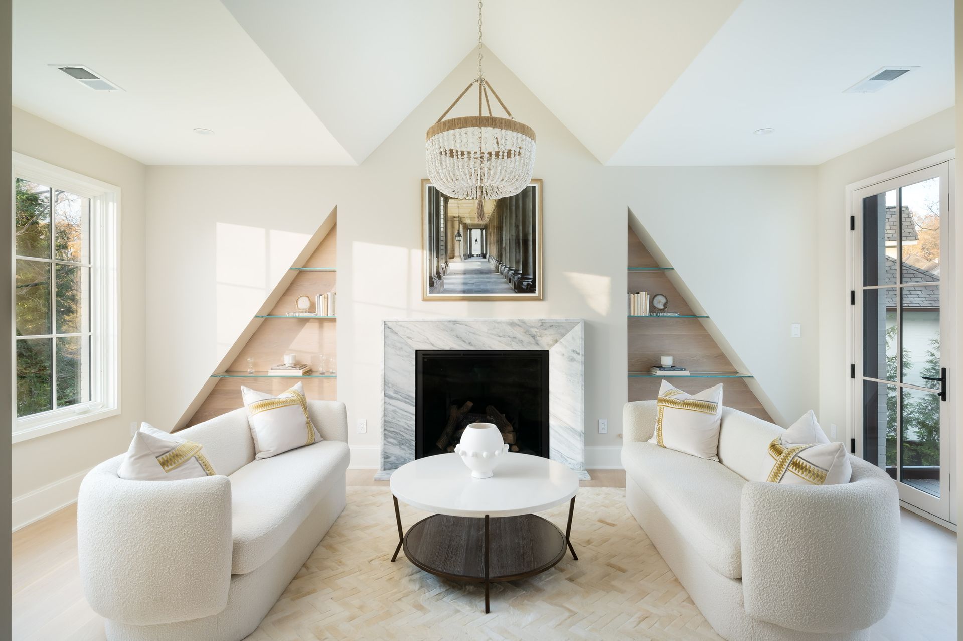 A living room with two couches and a fireplace.