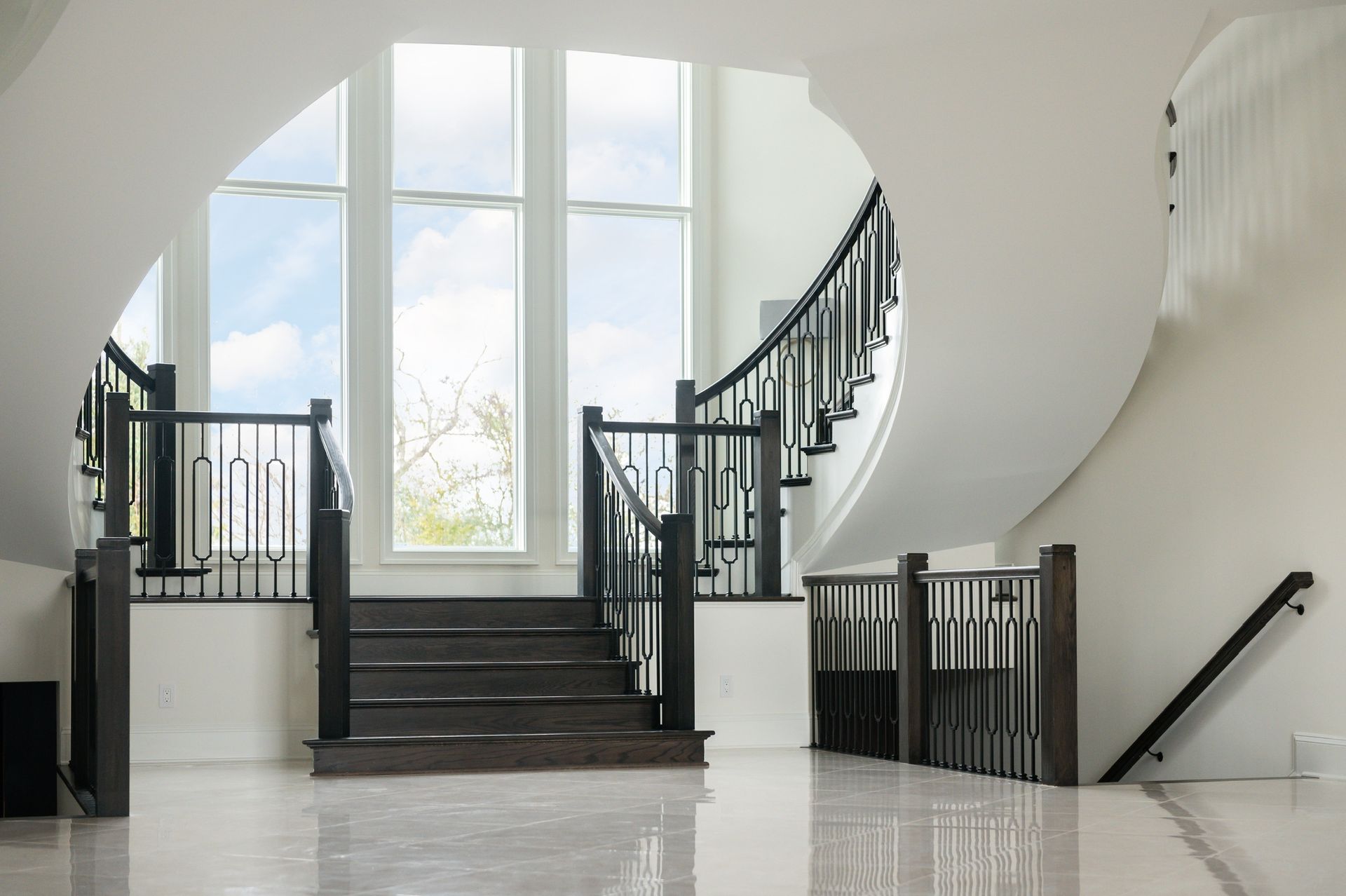 There is a curved staircase in the middle of the room.