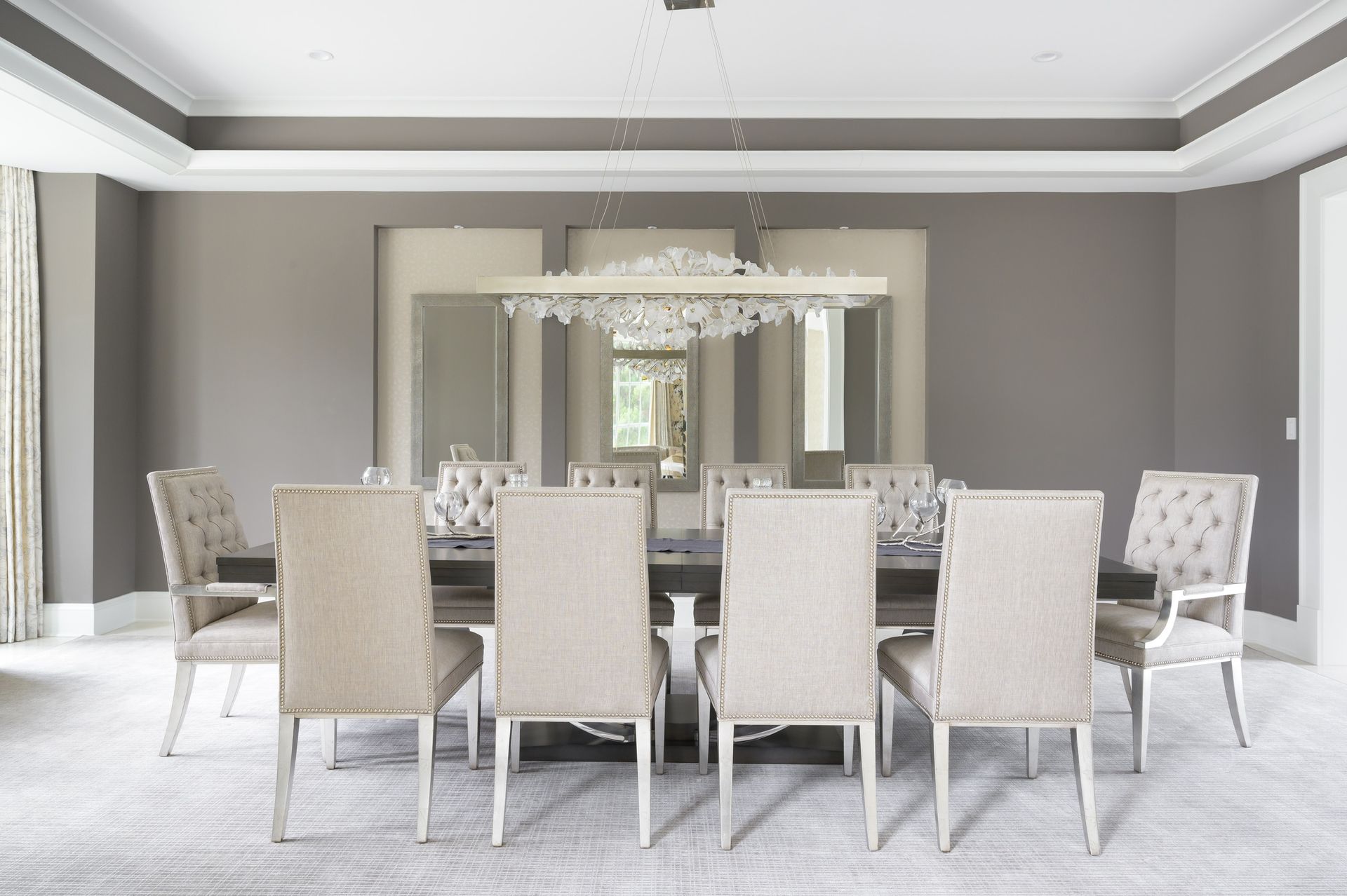 A dining room with a long table and chairs