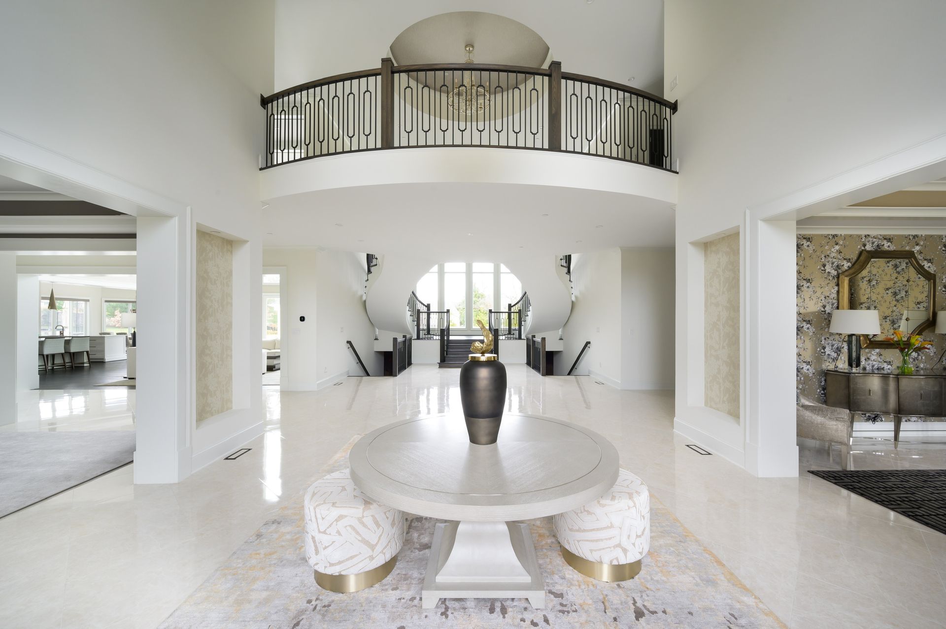 A large white room with a round table in the middle