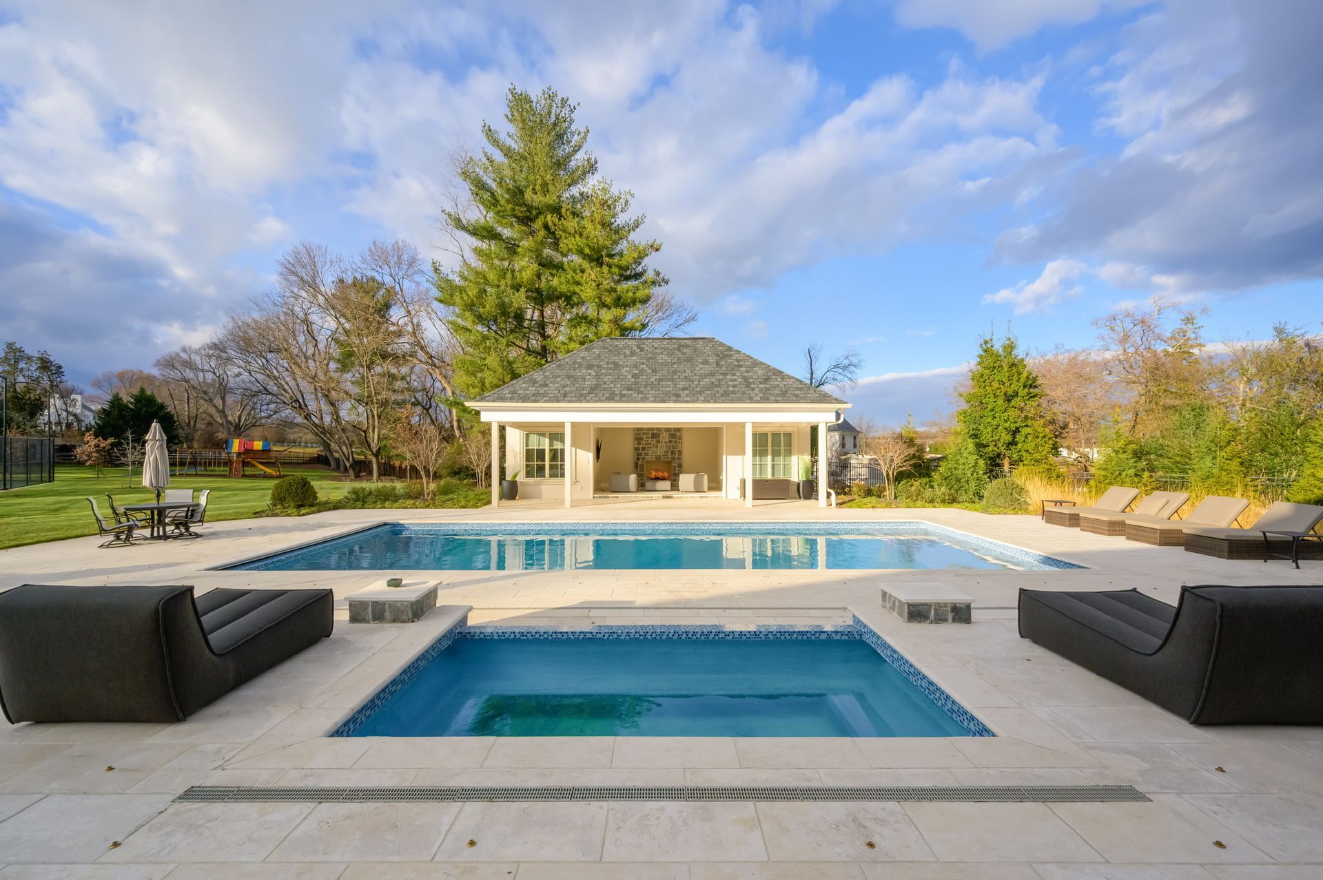 A large swimming pool with a gazebo in the background.