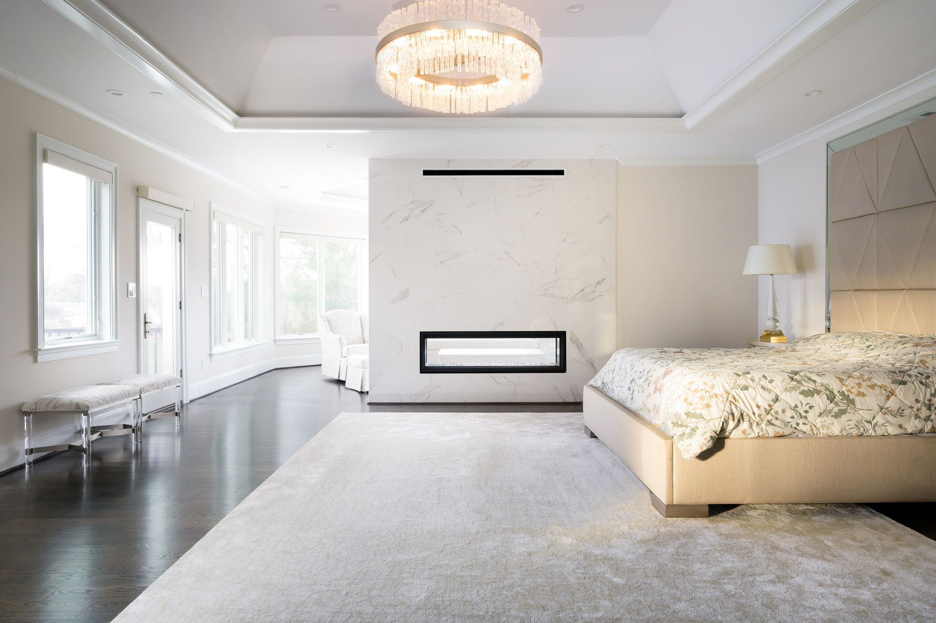 A bedroom with a large bed and a fireplace