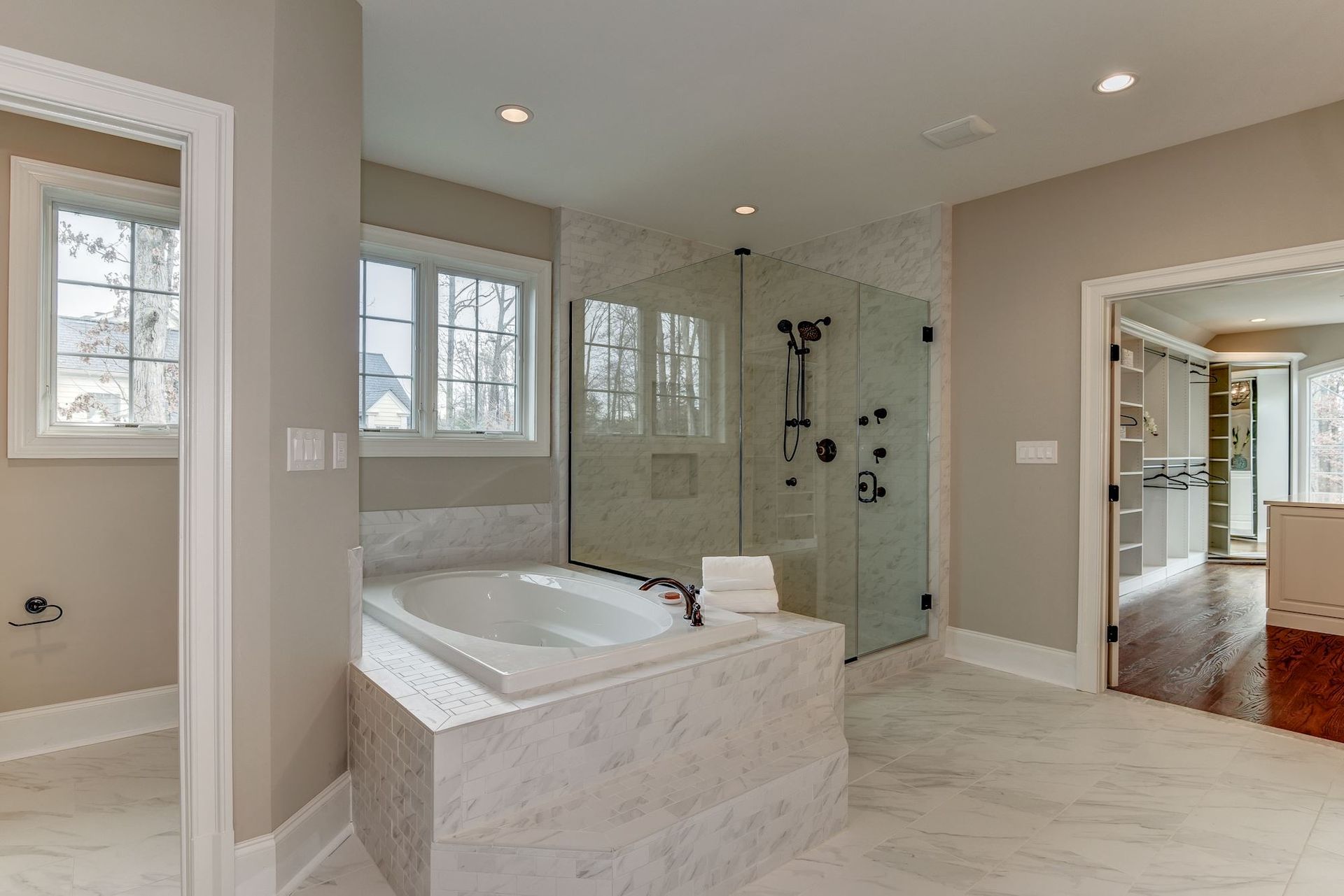 A large bathroom with a tub and a walk in shower.