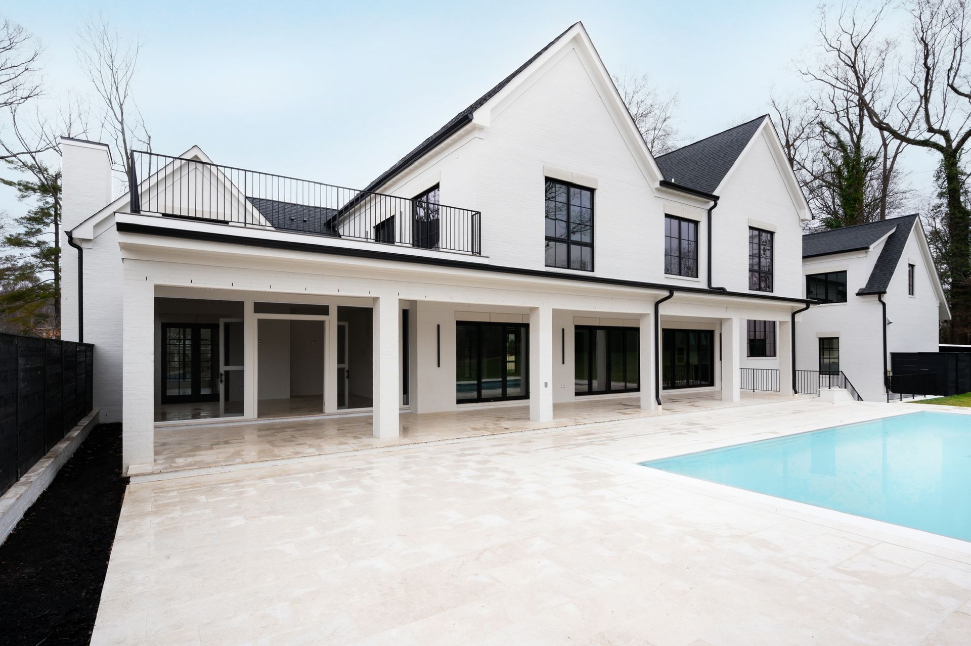 A large white house with a swimming pool in front of it