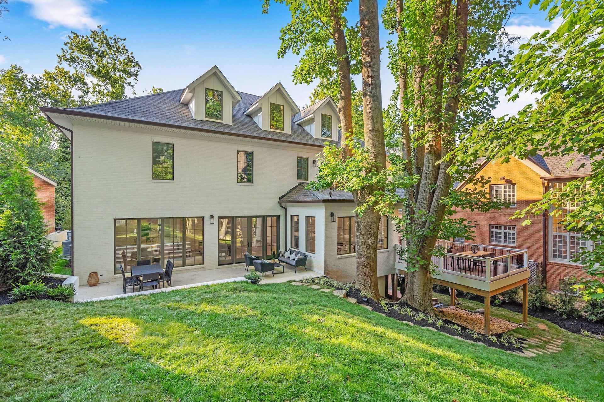 A large white house with a large lawn in front of it.
