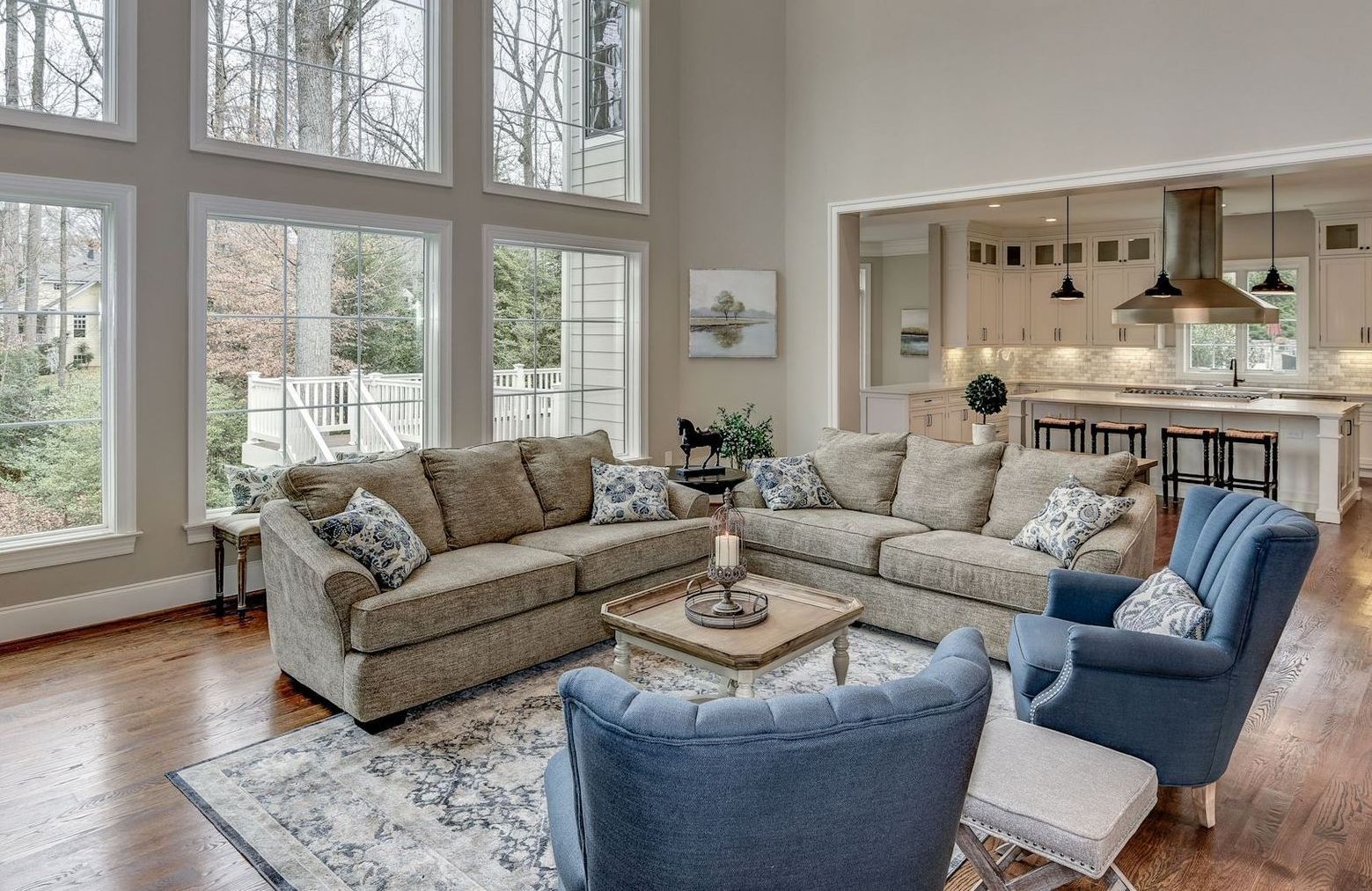 A living room filled with furniture and lots of windows.