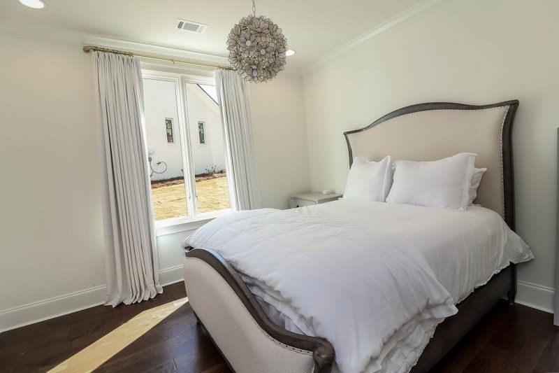 A bedroom with a large bed and a window.