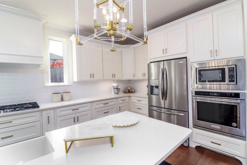 A kitchen with white cabinets and stainless steel appliances.
