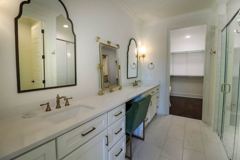 A bathroom with two sinks and two mirrors