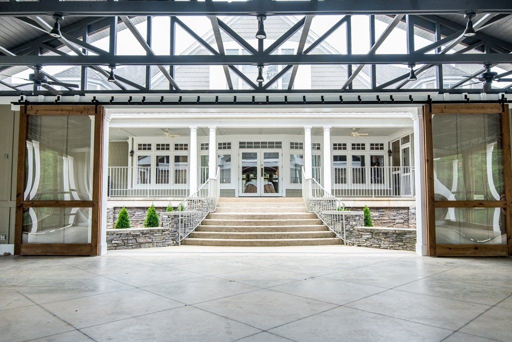 A large white house with a porch and stairs