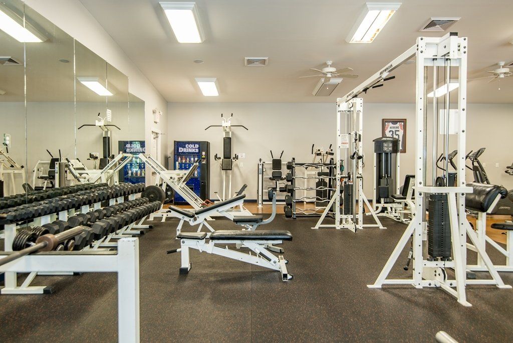 A large gym filled with lots of exercise equipment