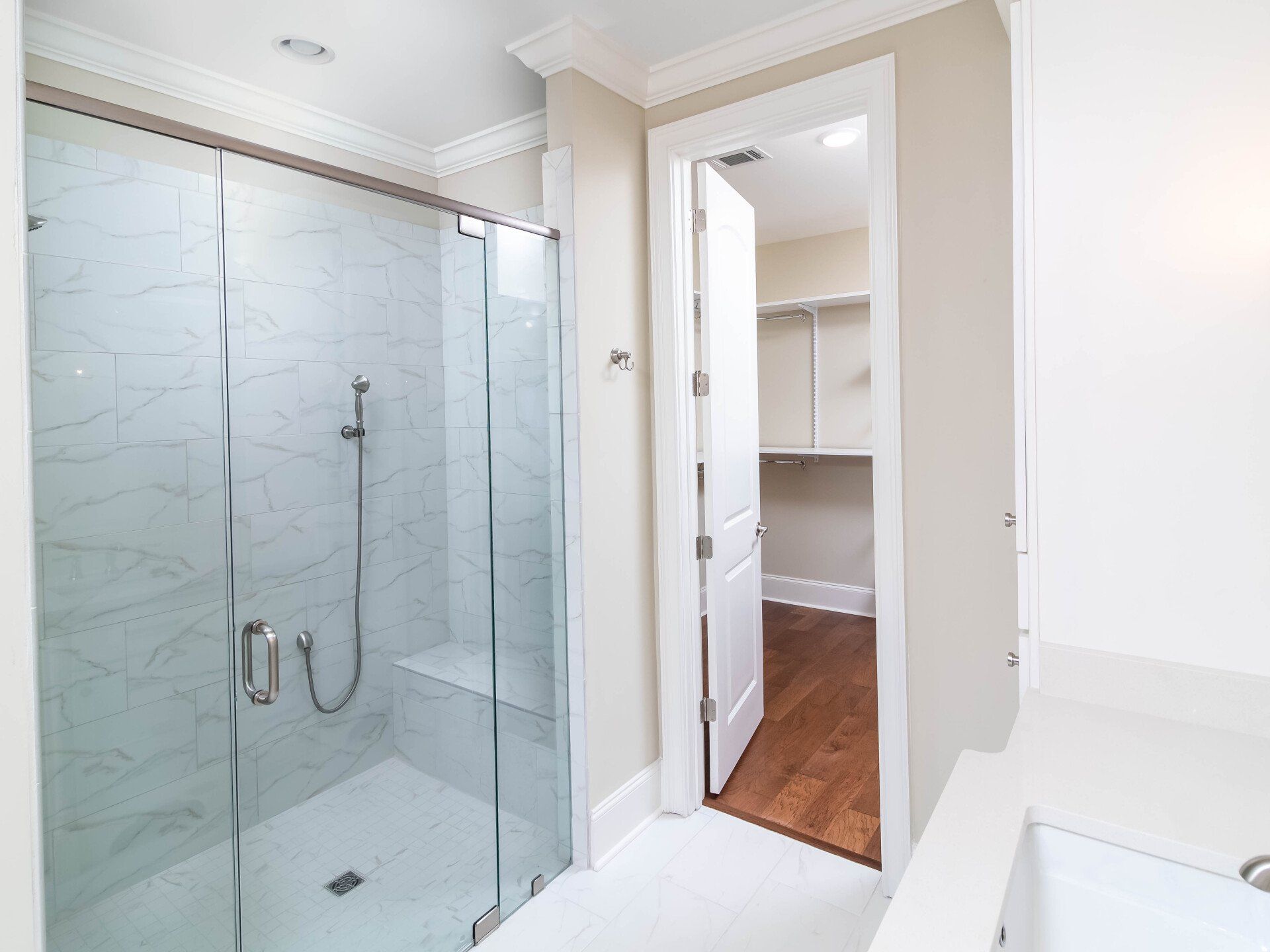 A bathroom with a walk in shower and a bathtub.