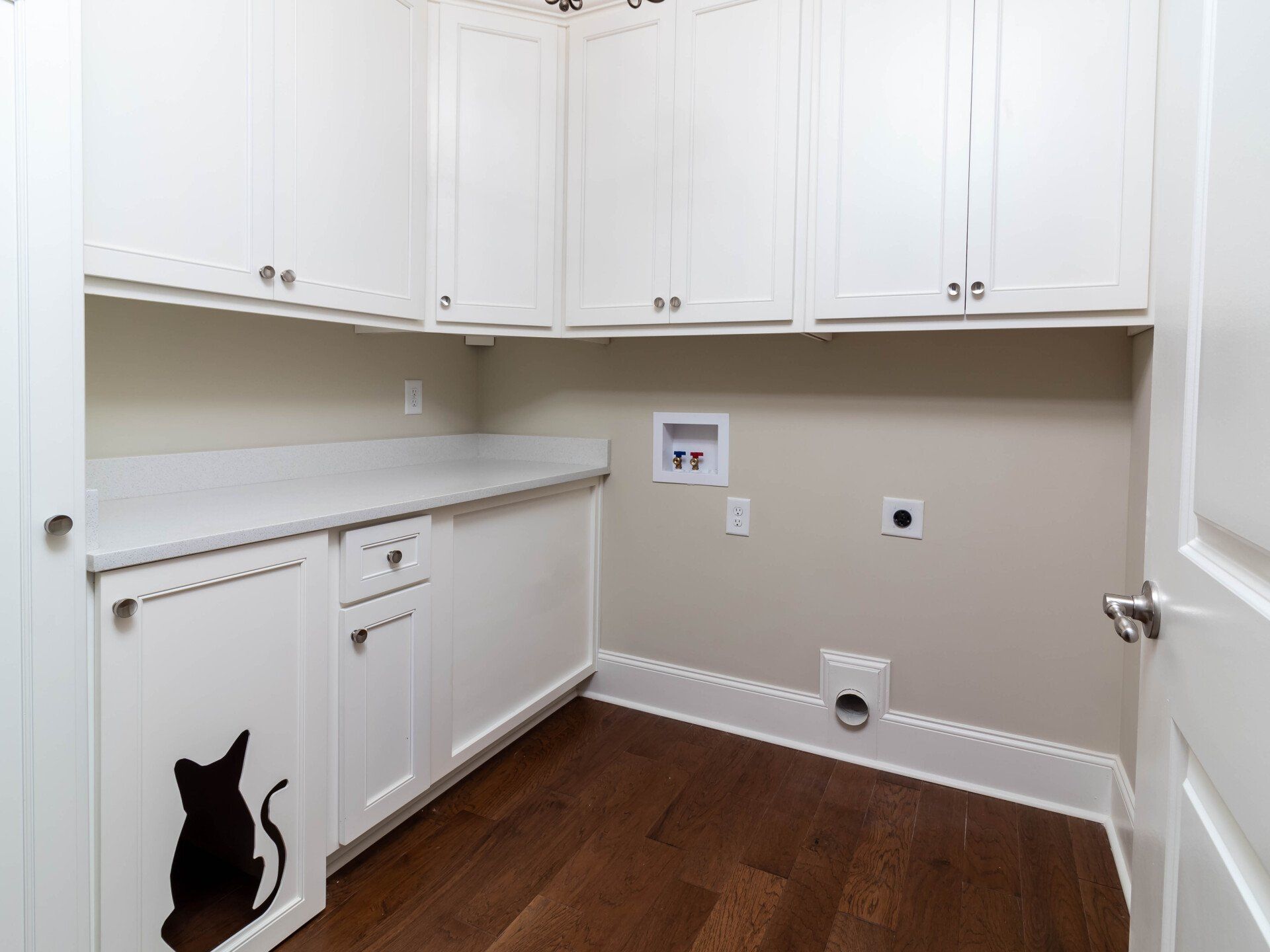 There is a cat litter box in the laundry room.