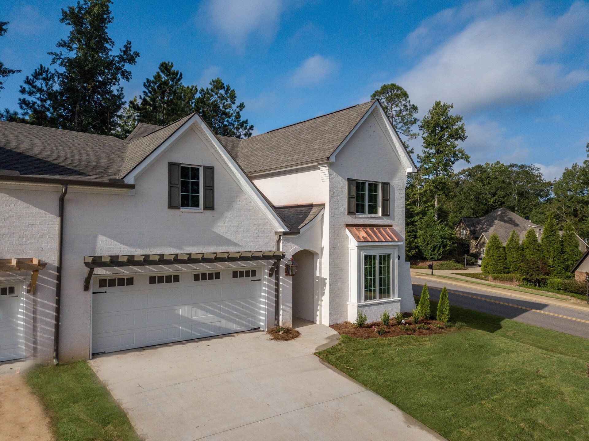 A white house with a garage and a driveway