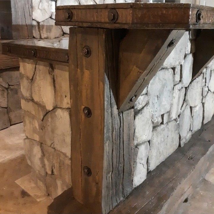 A wooden beam is attached to a stone wall