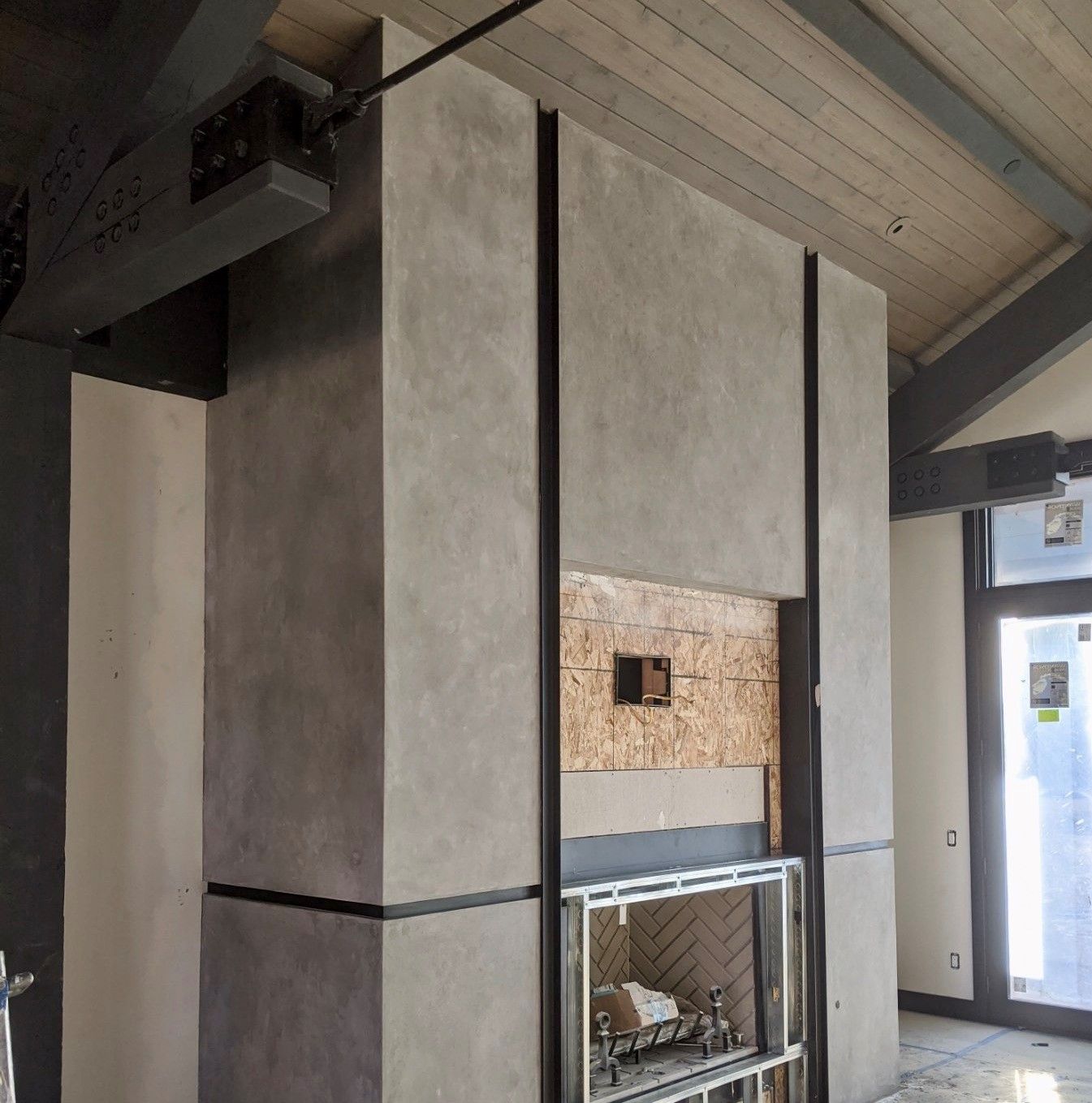 A fireplace in a room with a wooden ceiling