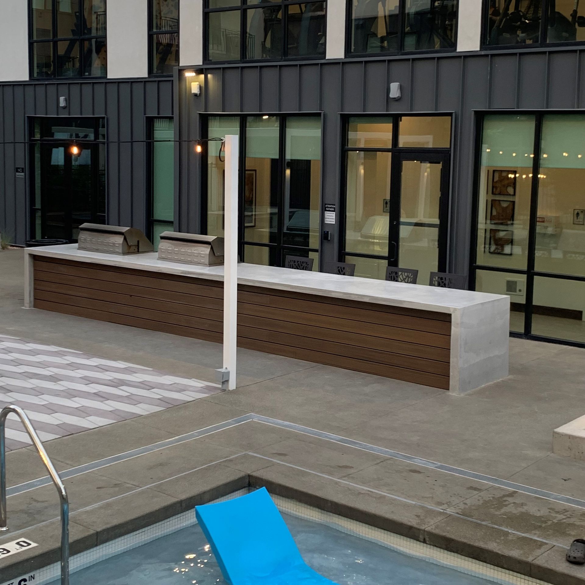 A large building with a swimming pool in front of it