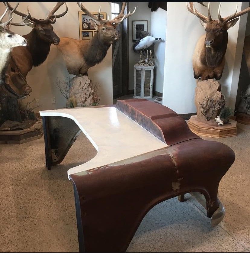 A close up of a counter top with a reflection of a window.