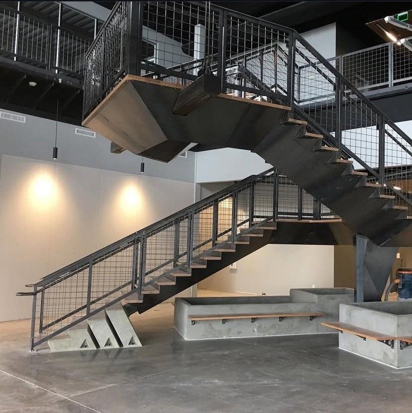 A row of round tables are lined up against a wall