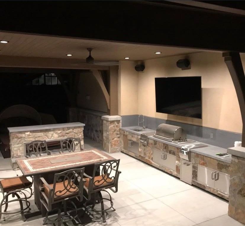 A large room with a white marble floor and a pool table.