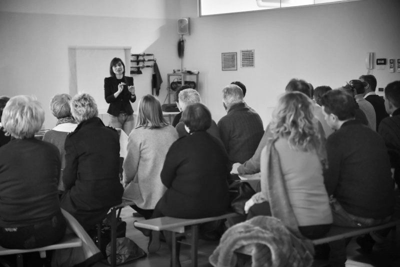 Una donna sta facendo una presentazione a un gruppo di persone