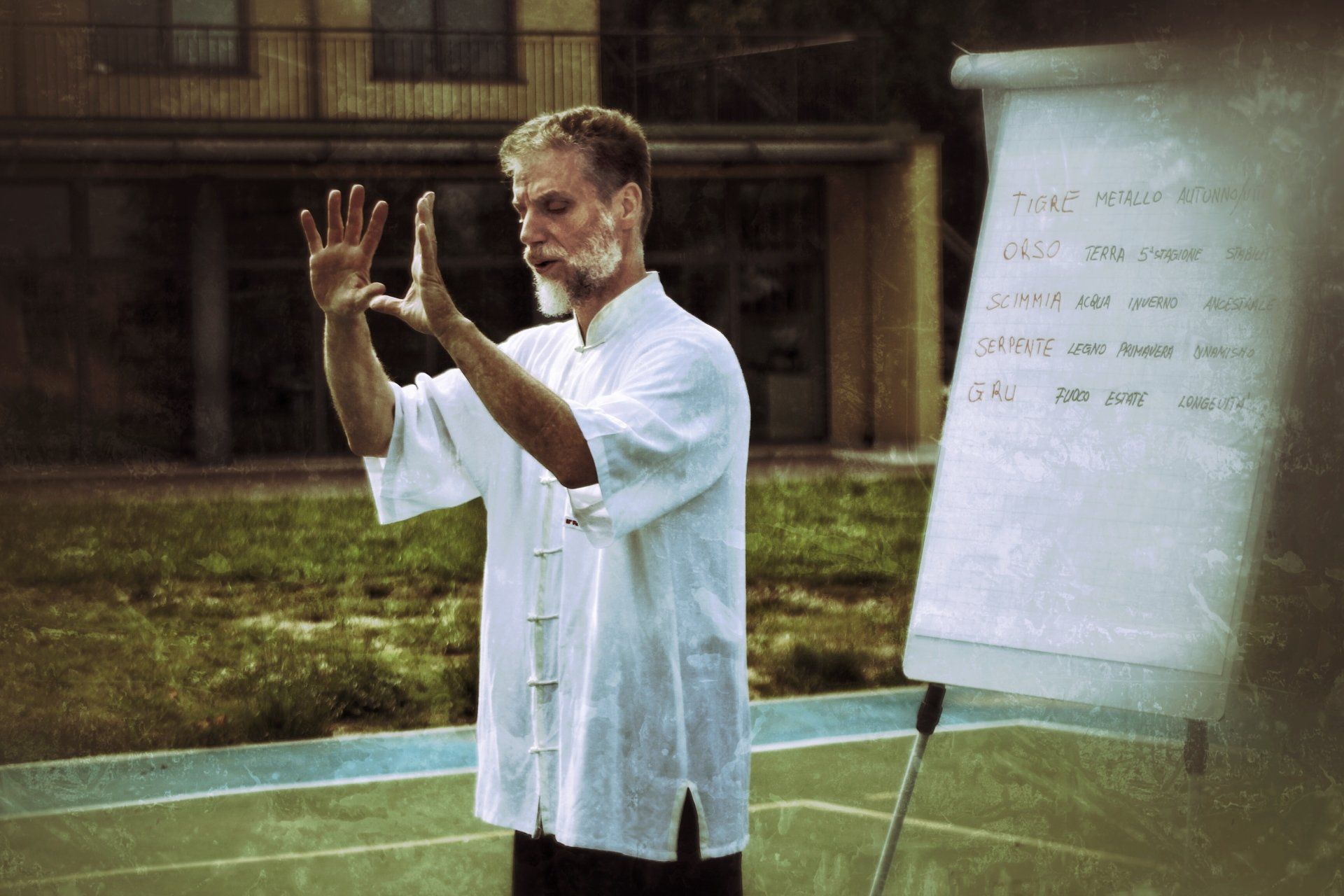 Un uomo con una camicia bianca è in piedi davanti a una lavagna bianca.