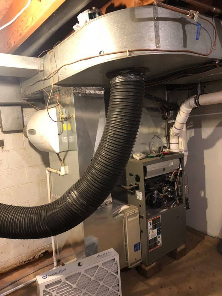 A large hose is coming out of the ceiling of a house.