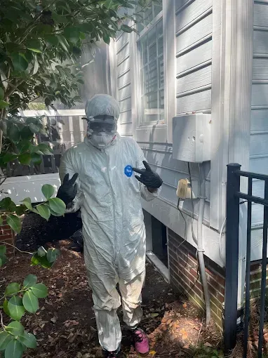 Person in a white hazmat suit giving the 