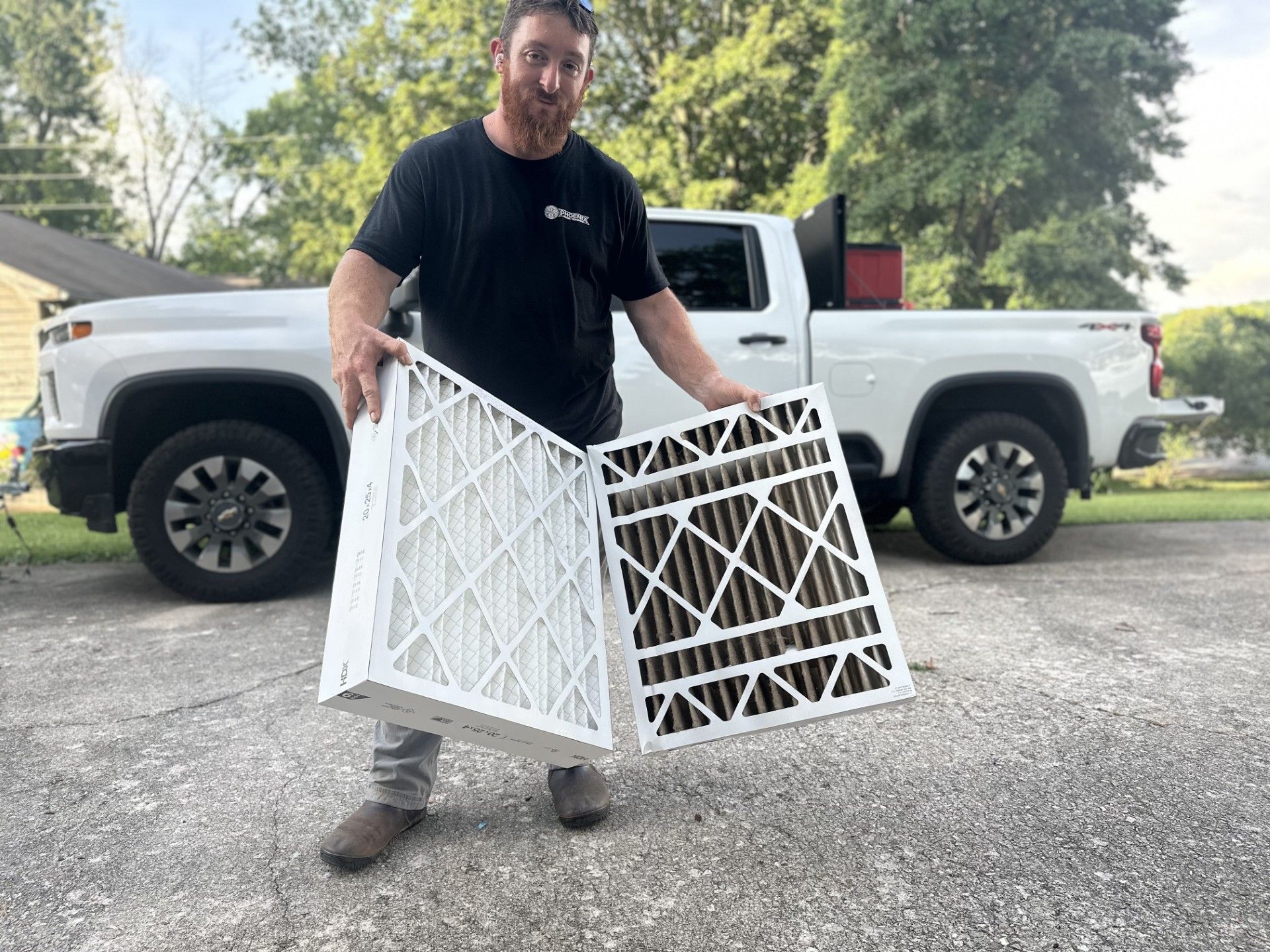 Family laughing, celebrating in their new home, with a girl in overalls and boy on dad's back.