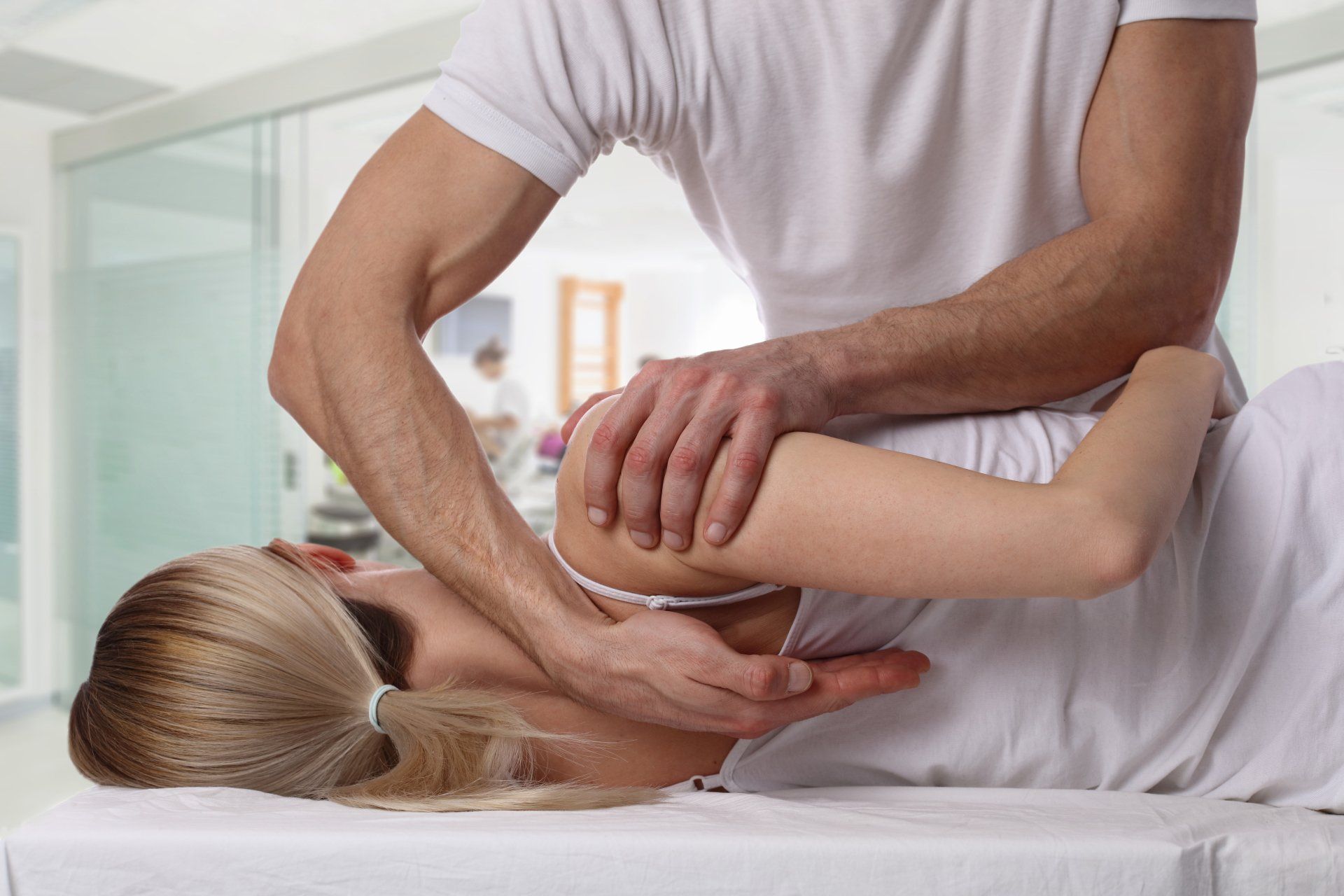 A Chiropractor Checking A Man's Arm — Anoka, MN — North Country Chiropractic
