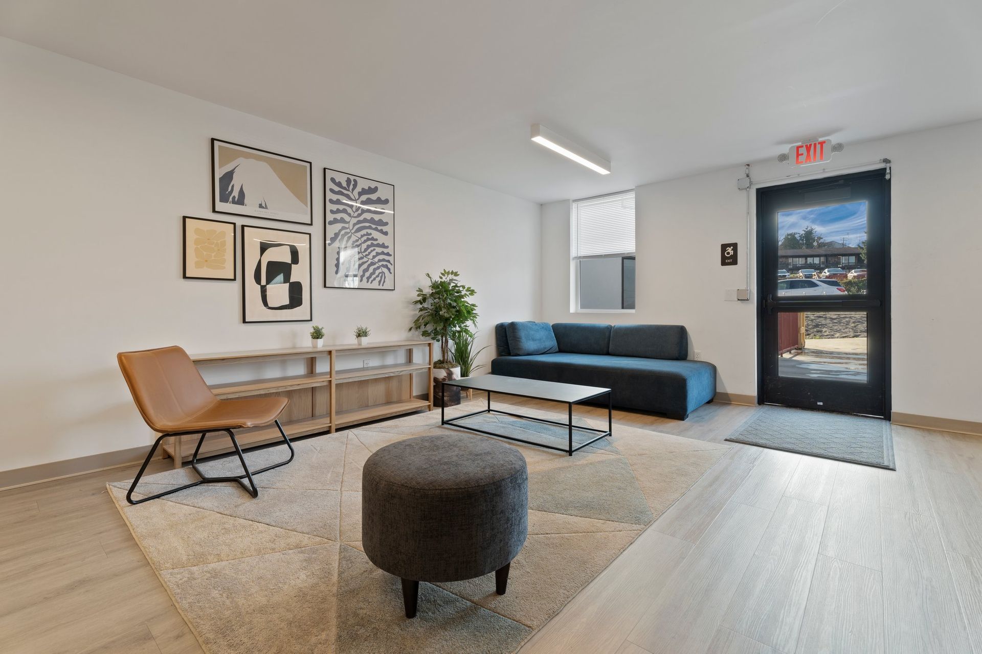 a living room with an exit sign above the door