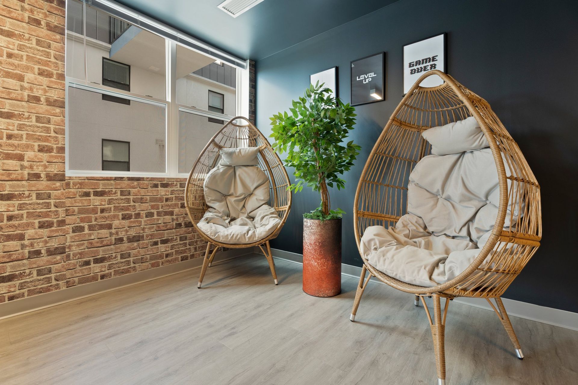 two wicker chairs in a room with posters on the wall that say game over