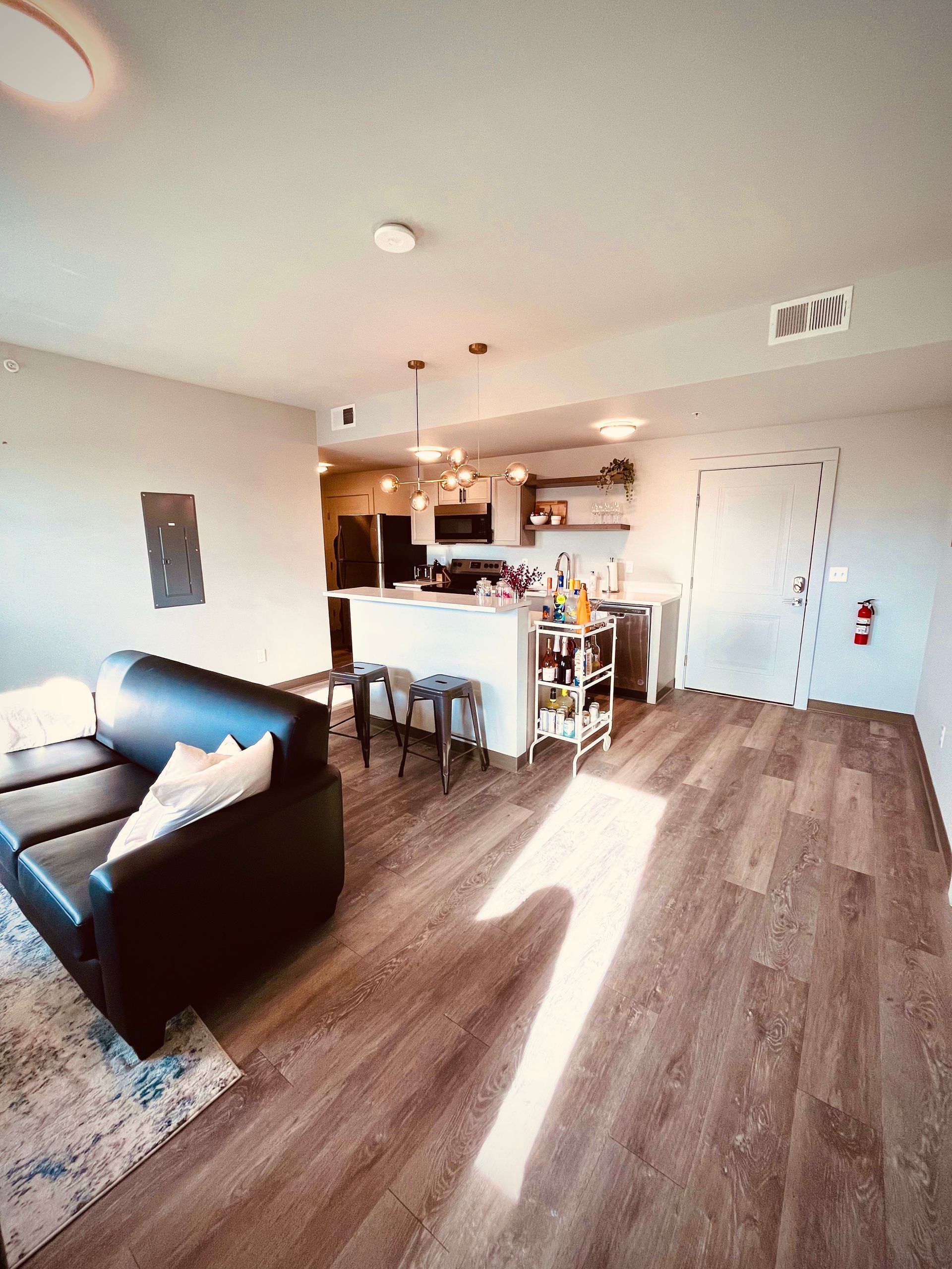 a living room with a couch and a fire extinguisher