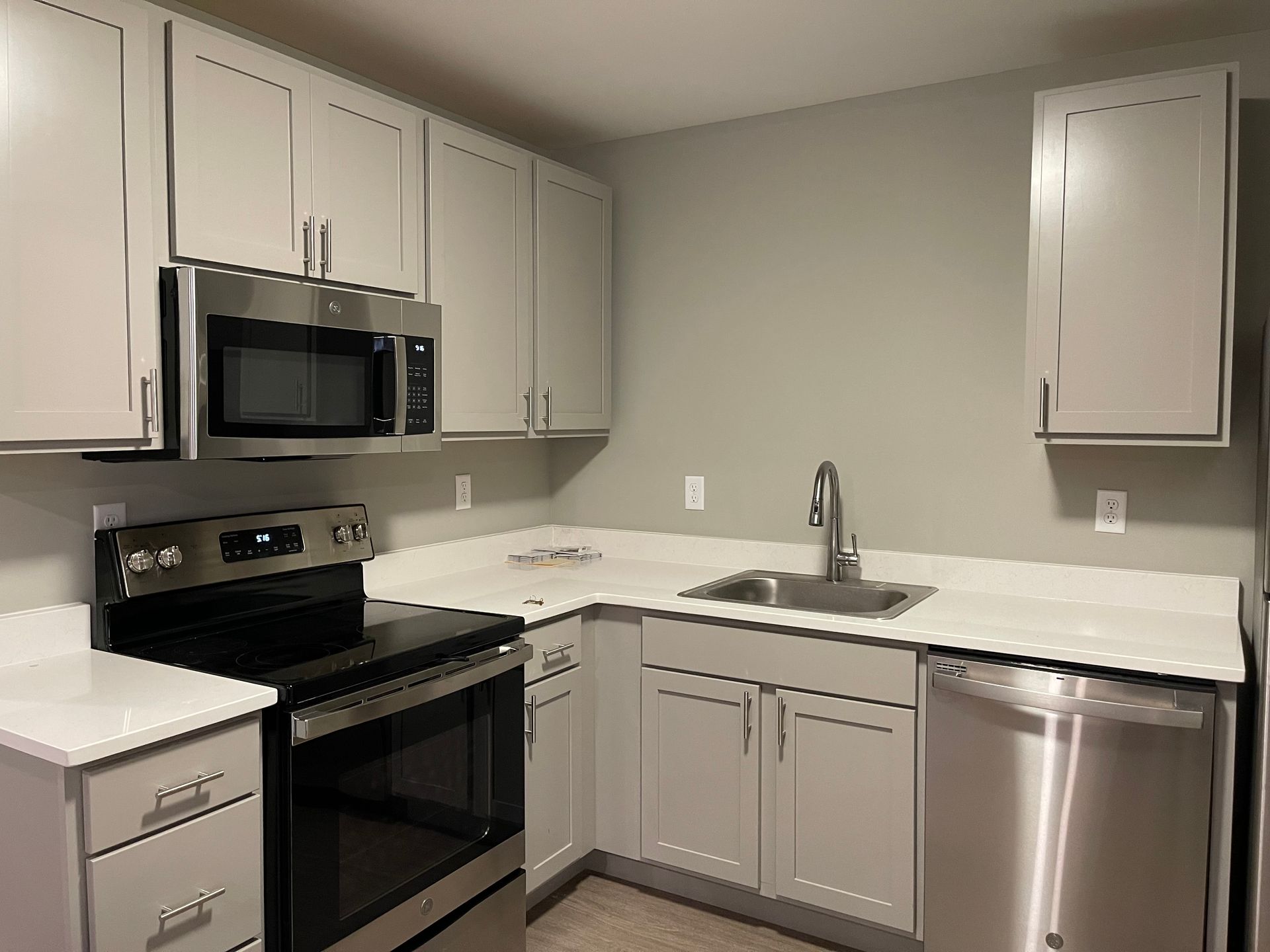 a kitchen with stainless steel appliances and white cabinets