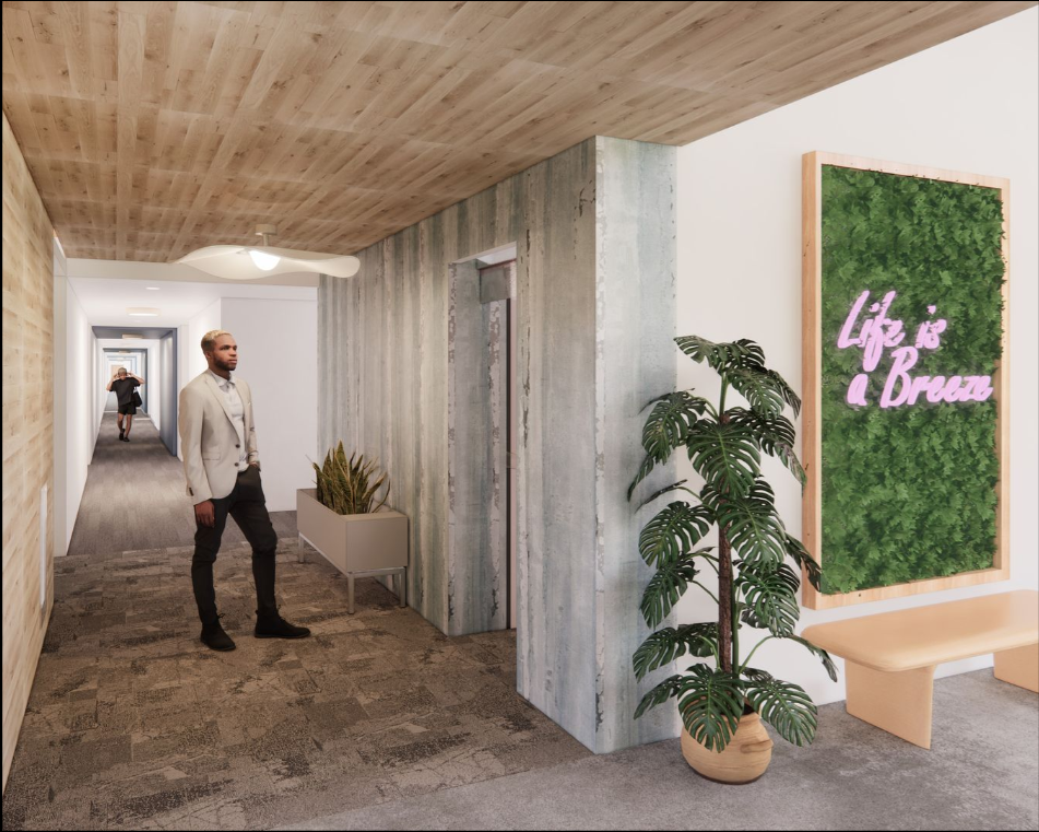 Hallway with a man walking, elevator, art piece, and greenery.