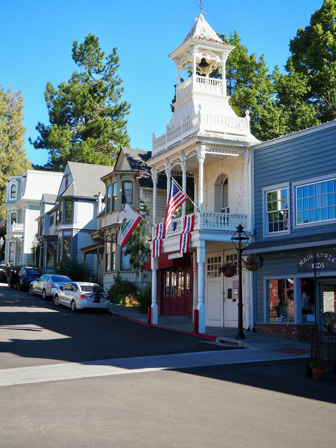 Historic downtown Nevada City featuring the Firehouse Museum with its iconic white bell tower and surrounding charming storefronts.