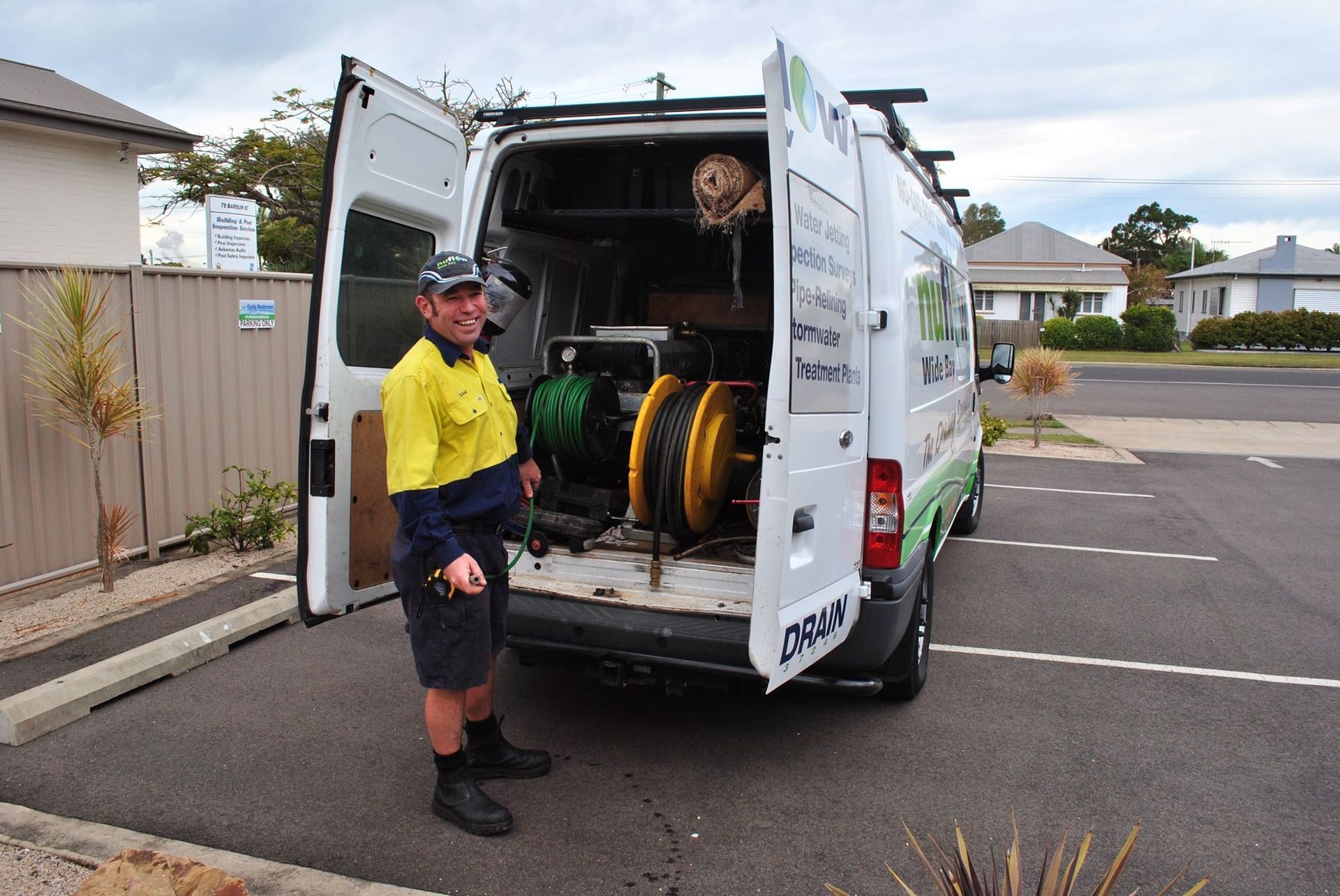 A Man Standing by Open Van with Equipment — Nuflow Wide Bay in Bundaberg South, QLD