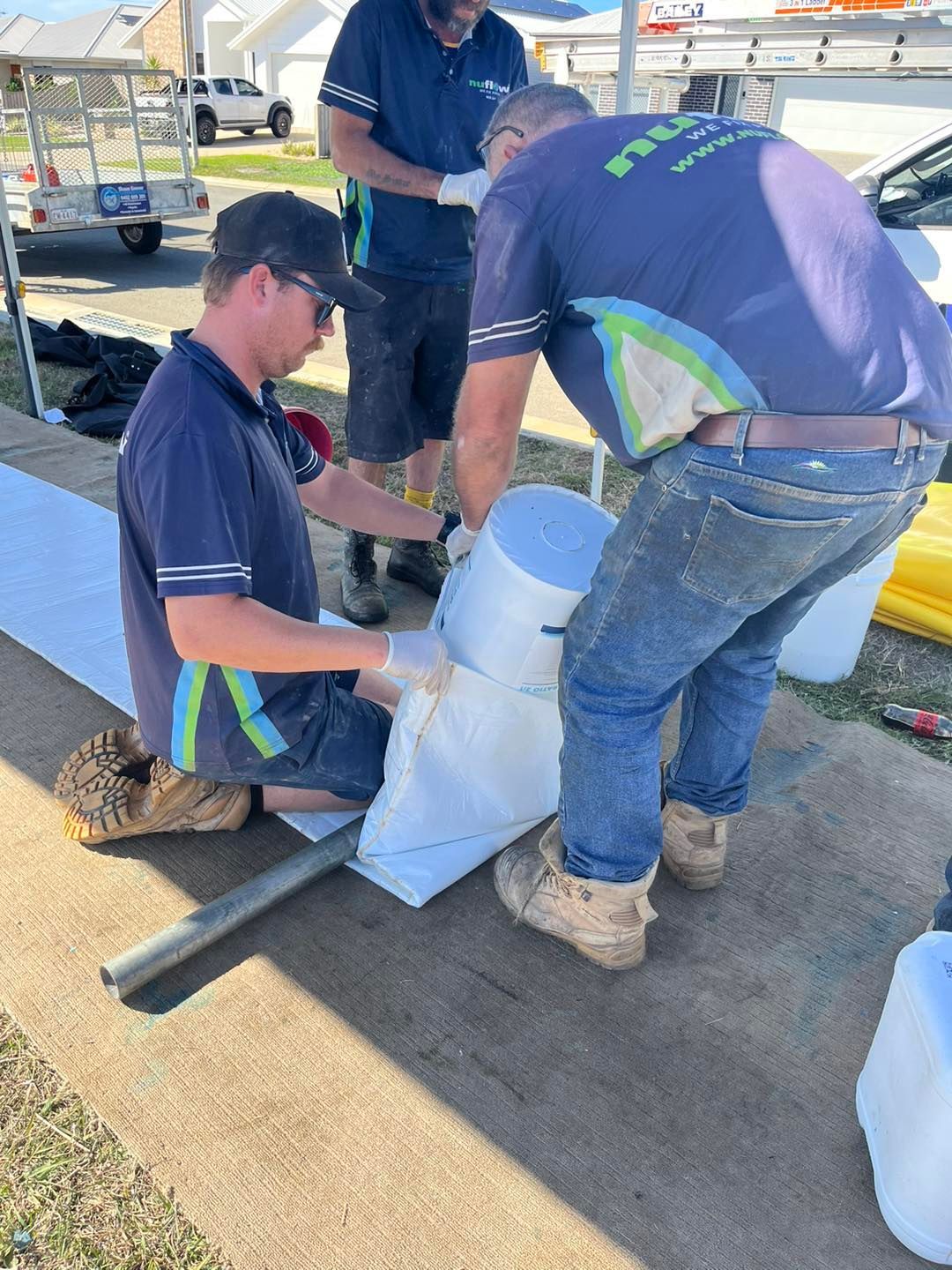 A Men Filling Sandbags on A Sidewalk — Nuflow Wide Bay in Bargara, QLD