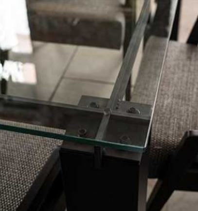 Dining room: table with six chairs, a hanging black light, and a wooden shelf.