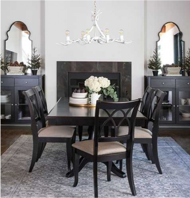 Dining room with dark table, chairs, chandelier, fireplace, and two side cabinets.